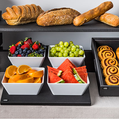 Buffet with assorted fruit and bread rolls